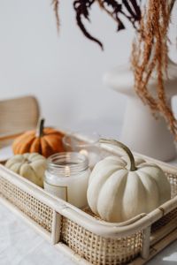 Kaboompics - Pumpkin and Candle Arrangement in a Wicker Tray