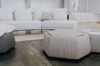 Kaboompics - Round Gray Fabric Ottoman with White Sectional Sofa Display in the Background