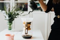 Kaboompics - Woman Brewing Pour-Over Coffee at a Bright Home Office Desk