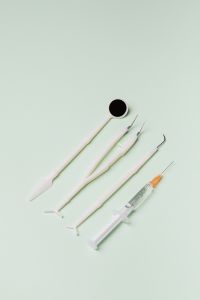 Kaboompics - Dental Tools and Syringe with Negative Space on Mint