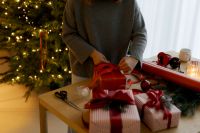 Kaboompics - Person Cutting Red Ribbon for Christmas Gift