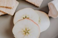 Kaboompics - Fresh Apple Slices and Whole-Grain Crispbread with Soft Cheese, Neutral Healthy Snack Close-Up