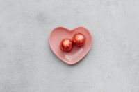Kaboompics - Two Chocolate Truffles in a Pink Heart-Shaped Dish