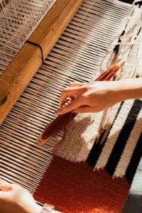 Kaboompics - Woman Weaving a Striped Textile by Hand