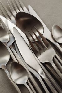 Kaboompics - Close-Up Matte Steel Knife, Fork and Spoon on Neutral Surface