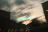 Kaboompics - Experimental Turquoise Light Trail against a Cloudy Urban Sky