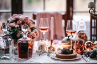 Kaboompics - Festive Christmas Table with Wine, Flowers and Dessert