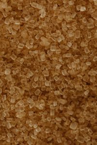 Kaboompics - Portrait Brown Sugar Crystals with Amber and Espresso Tones, Food Texture Background