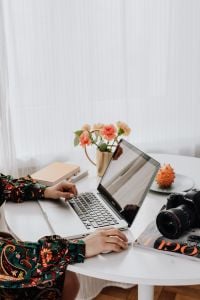 Kaboompics - Creative Workspace with Laptop, DSLR Camera and Carnations
