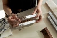 Kaboompics - Hands Arranging Marble, Stone and Dried Botanical Samples
