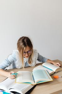 Kaboompics - Young Woman Studying with Open Textbooks