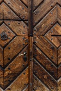 Kaboompics - Vertical Detail of Weathered Wooden Door With Metal Hardware