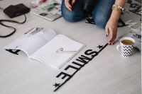Kaboompics - Woman Sorting Alphabet Letters on a Dark Table