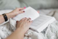 Kaboompics - Soft photo of woman on the bed with the book