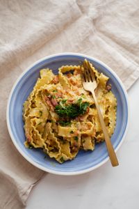 Kaboompics - Carbonara Pasta Flat Lay with Fork, Linen and Copy Space