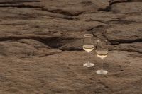 Kaboompics - Wide Rocky Shore with Two White Wine Glasses