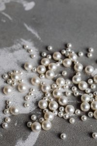 Kaboompics - Pearl Bead Flat Lay on Gray Concrete with Large Copy Space Above