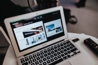 Kaboompics - White laptop on a table with a remote