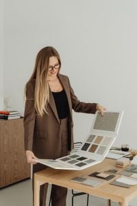 Kaboompics - Woman Displaying Large Catalog of Neutral Interior Finish Samples