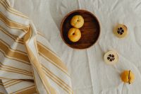 Kaboompics - Overhead Chaenomeles Still Life with Whole and Sliced Japanese Quince on White Linen