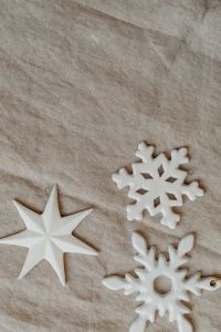 Kaboompics - Minimal Linen Holiday Background with White Star and Snowflake Decorations