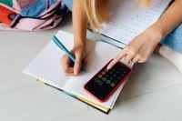 Kaboompics - Student Using Phone to Check Math Work