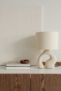 Kaboompics - Sculptural Lamp and Wooden Bowl on Interior Design Books with Copy Space