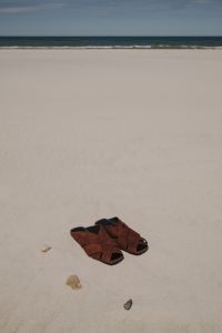 Kaboompics - Brown Leather Sandals on an Empty Beach