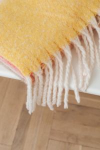 Kaboompics - Yellow Fringed Blanket on a Wooden Floor