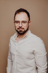 Kaboompics - Bearded Man with Glasses in a White Shirt, Three-Quarter Studio Portrait for Corporate Profiles
