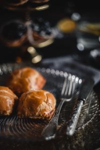 Kaboompics - Three Sweet Buns with Coffee and a Tiered Pastry Stand