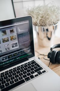 Kaboompics - Macbook pro with headphones on a wooden desk