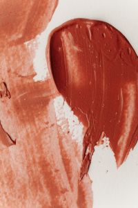 Kaboompics - Brown Lipstick Swatch on Terracotta Background