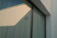 Kaboompics - Geometric Sunlight and Window Shadows on a Modern Glass Facade