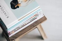 Kaboompics - Stack of magazines on the wooden stool
