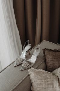 Kaboompics - Silver Rhinestone Slingback Pumps on a Charcoal Accent Chair