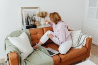 Kaboompics - Woman Sitting on Sofa with Laptop in Home Interior