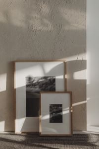 Kaboompics - Framed Black and White Artwork Leaning Against a Textured Wall