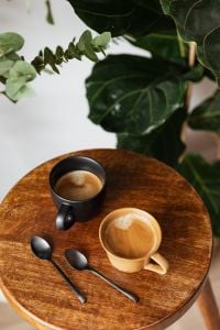 Rustic Coffee Still Life Photography with Ceramic Cups, Foamy Coffee and Wooden Table