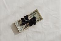 Kaboompics - Small Stacks of Dollar Bills on White Fabric