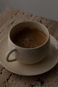 Kaboompics - Moody Coffee Cup on Travertine Table in Soft Light