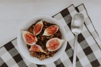 Kaboompics - Overhead Fig and Granola Breakfast Flat Lay with White Bowl, Spoon and Checkered Napkin