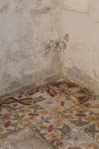 Kaboompics - Vintage Patterned Tile Floor and Peeling Plaster Wall Detail