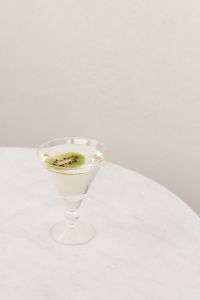 Kaboompics - Green Cocktail on a Round Table by Sheer Curtains