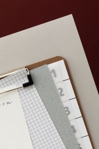 Kaboompics - Analogue Clipboard Collage with Layered Paper on Red Background