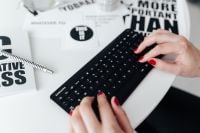 Kaboompics - Female hands typing on the remote wireless computer keyboard