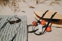 Kaboompics - Straw Bag, Sunglasses and Peaches on a Striped Towel