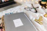 Kaboompics - January 2018 Planner With Gold Phone Case And Reading Glasses