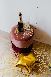 Kaboompics - Champagne Bottle And Flutes With Gold Star Balloon And Confetti