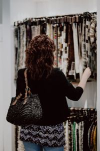 Kaboompics - Woman Comparing Upholstery Fabric Samples in a Store